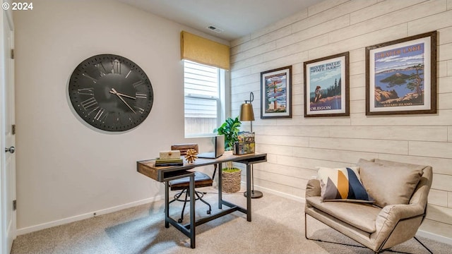 office area featuring light carpet and wooden walls