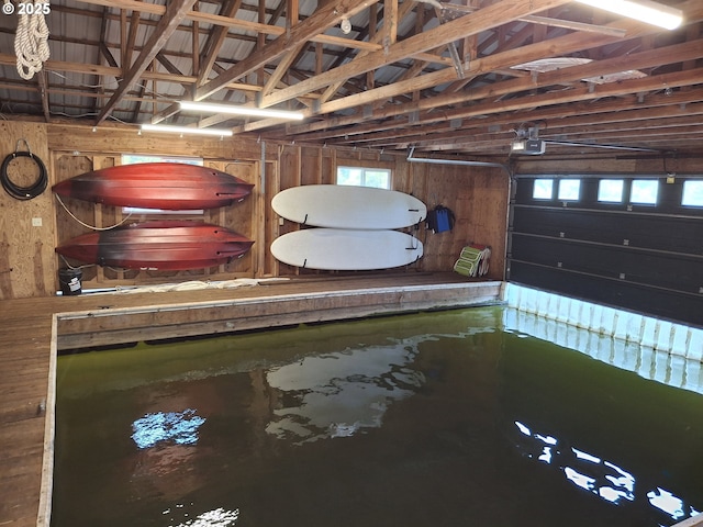 747 N Tenmile, Lakeside, OR 97449 - garage with wood walls and a garage door opener