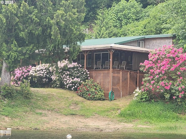 747 N Tenmile, Lakeside, OR 97449 - back of house with a view of trees and a metal roof
