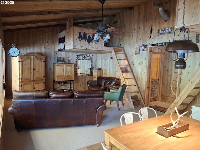 747 N Tenmile, Lakeside, OR 97449 - living room with wooden walls, ceiling fan, wood ceiling, carpet flooring, and stairs