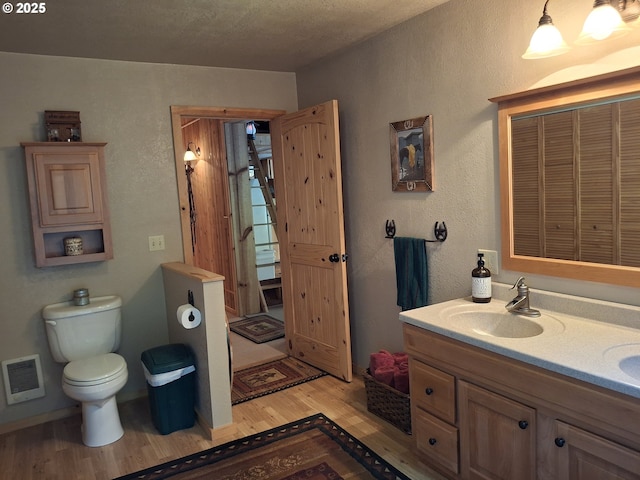 747 N Tenmile, Lakeside, OR 97449 - bathroom featuring wood finished floors, double vanity, and heating unit