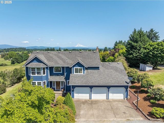 30174 SE Waybill Rd, Boring, OR 97009 - traditional home with concrete driveway, roof with shingles, a chimney, and a mountain view