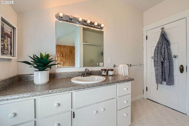 bathroom with vanity and a shower with door