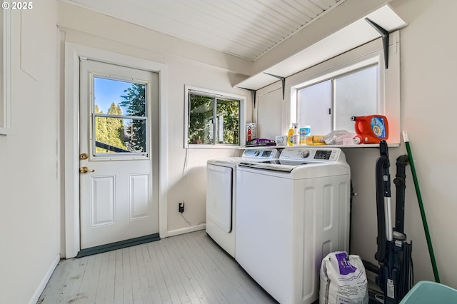 washroom featuring independent washer and dryer and light hardwood / wood-style flooring