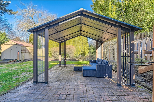 view of patio / terrace with a shed, an outdoor living space, and a gazebo