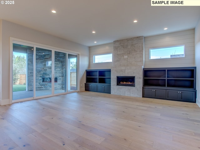 10216 NW Lee St, Portland, OR 97229 - unfurnished living room with a fireplace, wood finished floors, recessed lighting, and baseboards