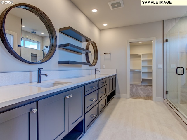 10216 NW Lee St, Portland, OR 97229 - full bath with a shower stall, double vanity, baseboards, recessed lighting, and a walk in closet