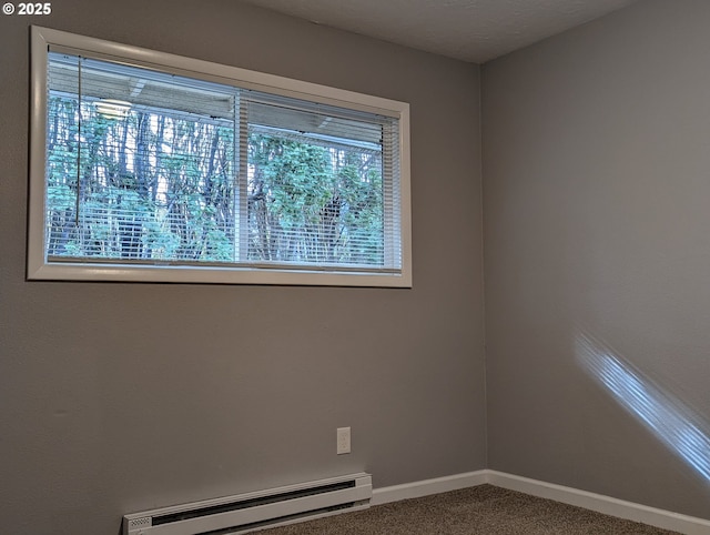 carpeted empty room with baseboard heating