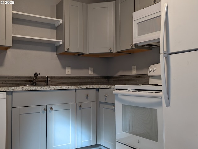 kitchen featuring gray cabinets, sink, and white appliances