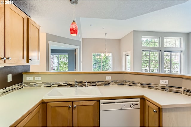 14700 SW Sandhill Loop Unit 204, Beaverton, OR 97007 - kitchen with dishwasher, a sink, light countertops, decorative light fixtures, and a textured ceiling