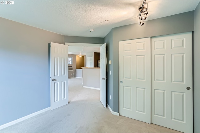 14700 SW Sandhill Loop Unit 204, Beaverton, OR 97007 - unfurnished bedroom featuring light colored carpet, a closet, a textured ceiling, and baseboards