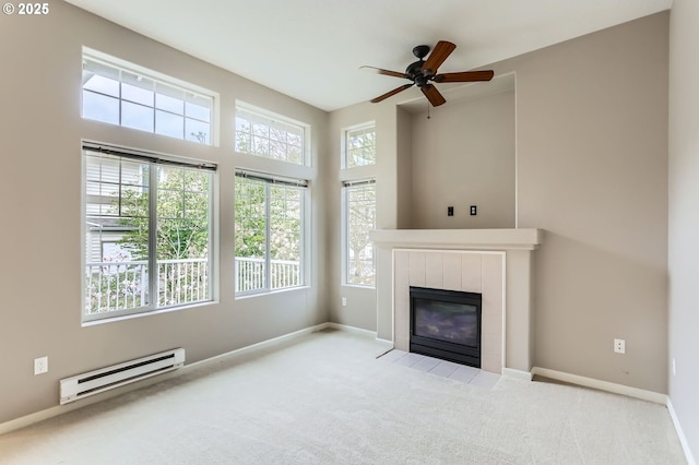 14700 SW Sandhill Loop Unit 204, Beaverton, OR 97007 - unfurnished living room featuring a baseboard radiator, a tile fireplace, carpet floors, ceiling fan, and baseboards