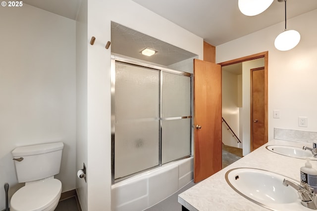 14075 SW Cherryhill Dr, Beaverton, OR 97008 - bathroom featuring double vanity, toilet, bath / shower combo with glass door, and a sink