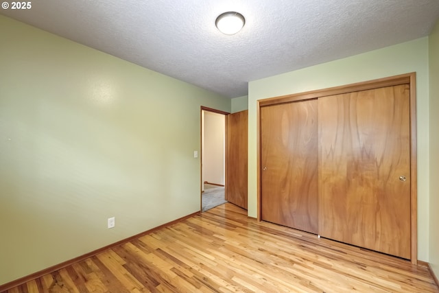 14075 SW Cherryhill Dr, Beaverton, OR 97008 - unfurnished bedroom featuring baseboards, a closet, a textured ceiling, and wood finished floors