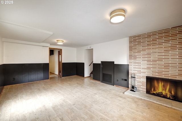 14075 SW Cherryhill Dr, Beaverton, OR 97008 - unfurnished living room featuring stairway, a fireplace, and wood finished floors