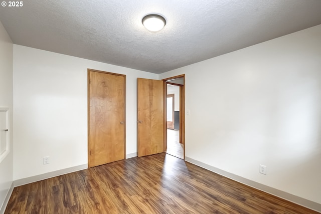14075 SW Cherryhill Dr, Beaverton, OR 97008 - unfurnished bedroom featuring a closet, a textured ceiling, wood finished floors, and baseboards