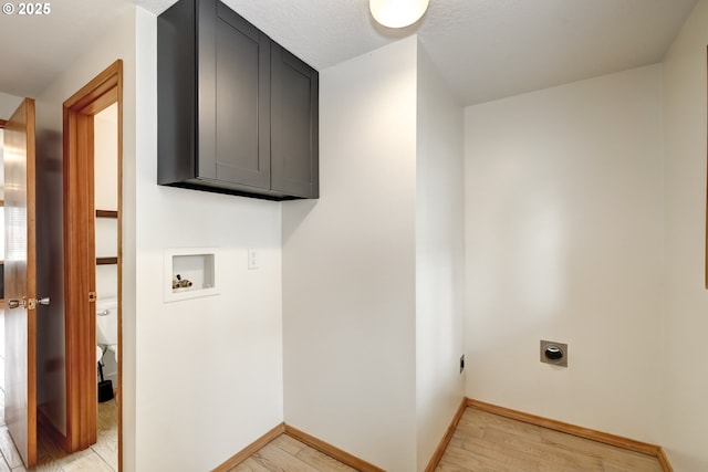 14075 SW Cherryhill Dr, Beaverton, OR 97008 - clothes washing area featuring cabinet space, washer hookup, hookup for an electric dryer, light wood-type flooring, and baseboards