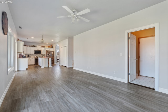 227 Hauser Ct, Molalla, OR 97038 - unfurnished living room with baseboards, recessed lighting, ceiling fan, and wood finished floors
