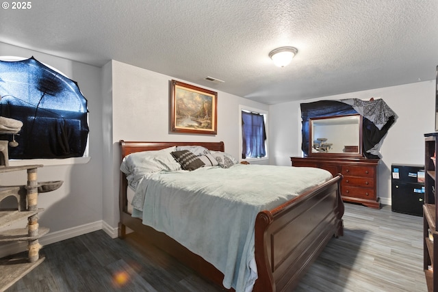 227 Hauser Ct, Molalla, OR 97038 - bedroom featuring wood finished floors, baseboards, and a textured ceiling