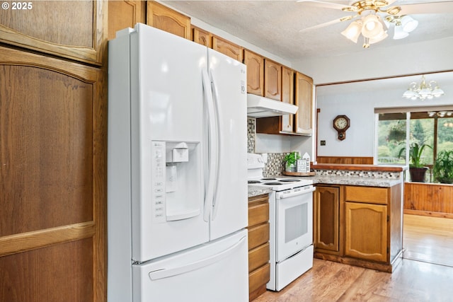 11754 Colvin Rd, Clatskanie, OR 97016 - kitchen featuring white appliances, under cabinet range hood, a peninsula, ceiling fan, and brown cabinets