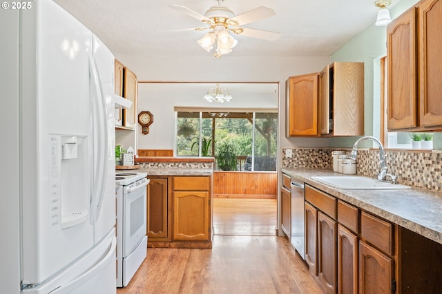 11754 Colvin Rd, Clatskanie, OR 97016 - kitchen with white appliances, a sink, light wood-type flooring, decorative backsplash, and ceiling fan