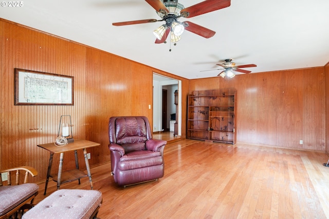 11754 Colvin Rd, Clatskanie, OR 97016 - living area featuring light wood finished floors, wooden walls, and ceiling fan