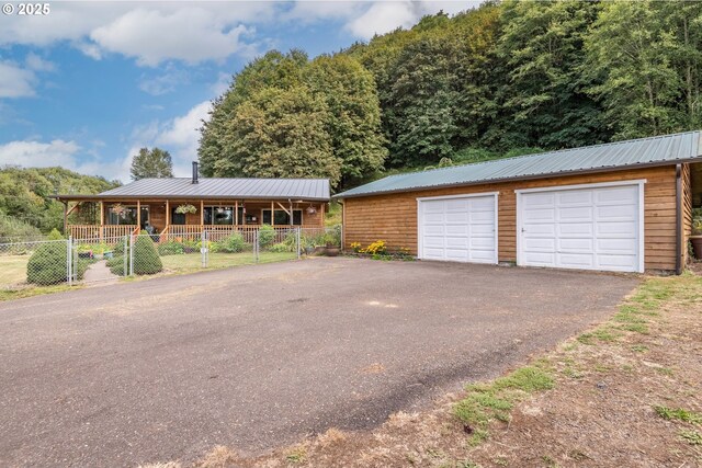 11754 Colvin Rd, Clatskanie, OR 97016 - view of front of home featuring fence, an outbuilding, metal roof, and a garage