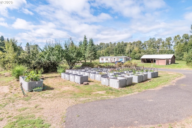 11754 Colvin Rd, Clatskanie, OR 97016 - view of property's community featuring a vegetable garden, an outdoor structure, and an outbuilding