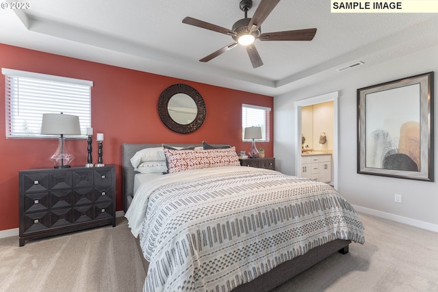 8518 NE 134th Ave Lot 89, Vancouver, WA 98682 - bedroom featuring light colored carpet, a tray ceiling, baseboards, a ceiling fan, and ensuite bath