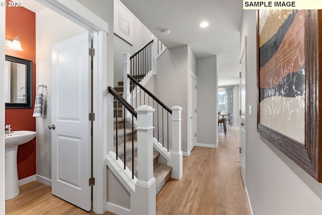 8518 NE 134th Ave Lot 89, Vancouver, WA 98682 - hallway with light wood-type flooring, baseboards, recessed lighting, and stairs