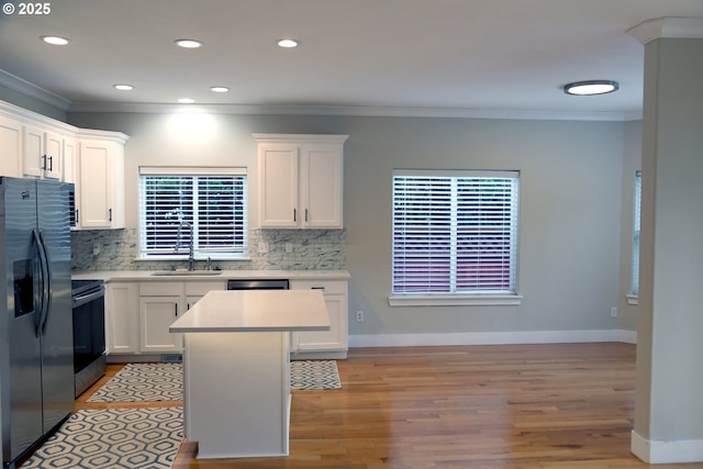 2659 SW Latourell Pl SW, Troutdale, OR 97060 - kitchen featuring range, stainless steel fridge, ornamental molding, tasteful backsplash, and light countertops