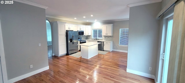 2659 SW Latourell Pl SW, Troutdale, OR 97060 - kitchen with appliances with stainless steel finishes, crown molding, light countertops, baseboards, and white cabinetry