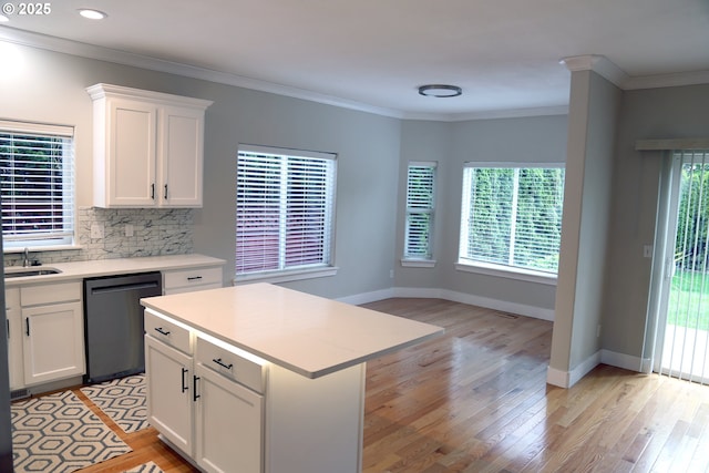 2659 SW Latourell Pl SW, Troutdale, OR 97060 - kitchen featuring dishwashing machine, light countertops, light wood-type flooring, plenty of natural light, and ornamental molding
