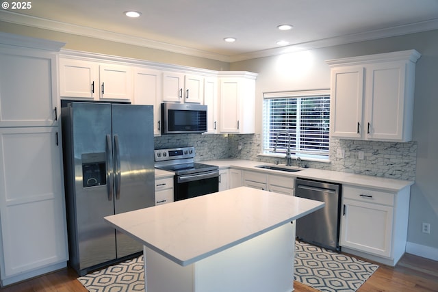 2659 SW Latourell Pl SW, Troutdale, OR 97060 - kitchen featuring appliances with stainless steel finishes, a sink, white cabinetry, light countertops, and light wood-style floors