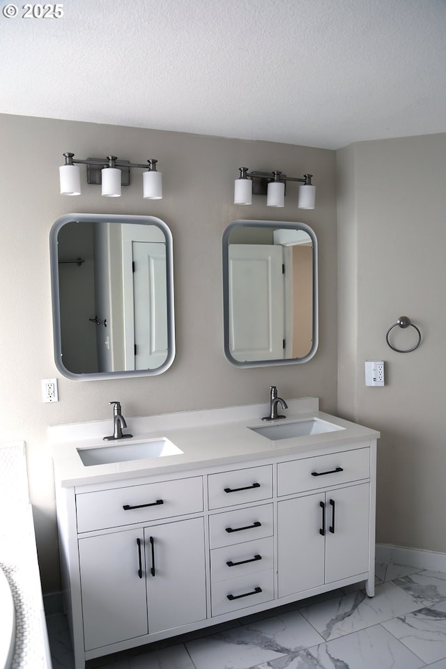 2659 SW Latourell Pl SW, Troutdale, OR 97060 - bathroom featuring double vanity, baseboards, marble finish flooring, and a textured ceiling