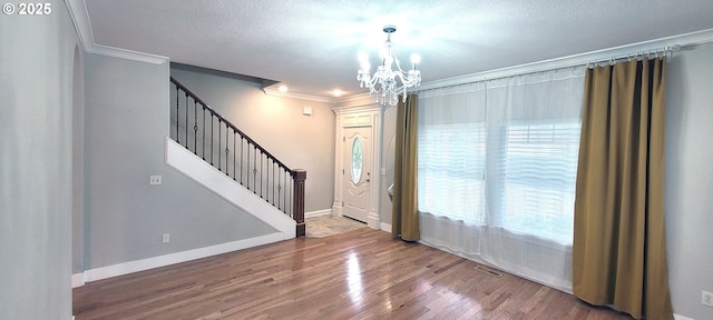 2659 SW Latourell Pl SW, Troutdale, OR 97060 - entryway with ornamental molding, a chandelier, plenty of natural light, stairway, and wood finished floors