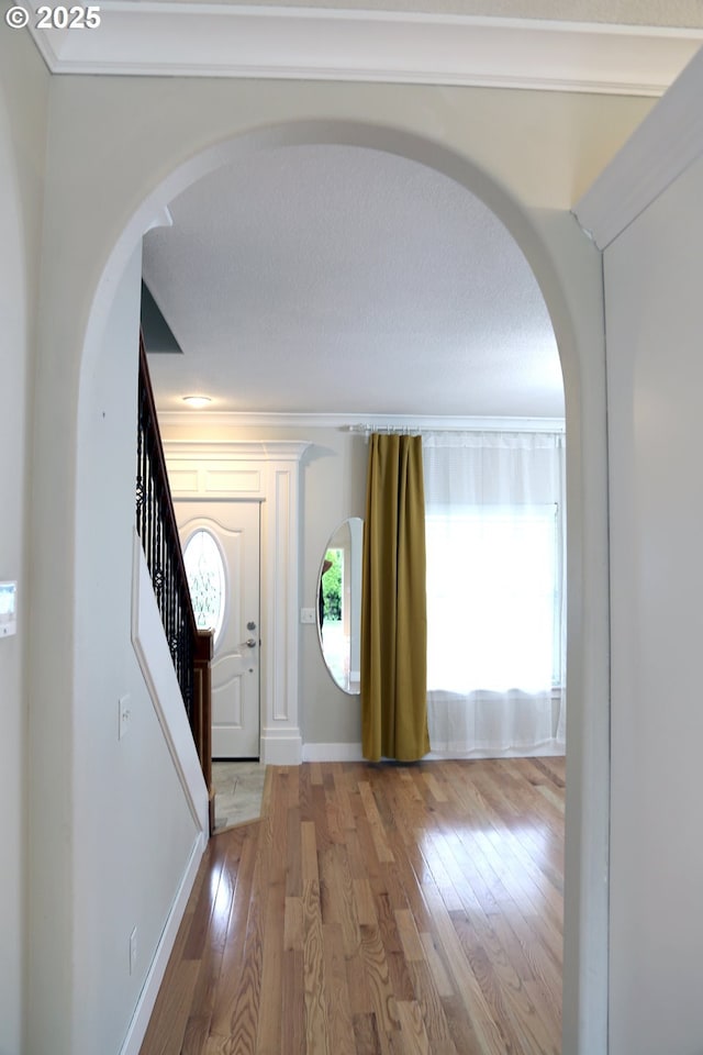 2659 SW Latourell Pl SW, Troutdale, OR 97060 - entryway featuring hardwood / wood-style floors, arched walkways, stairs, and baseboards