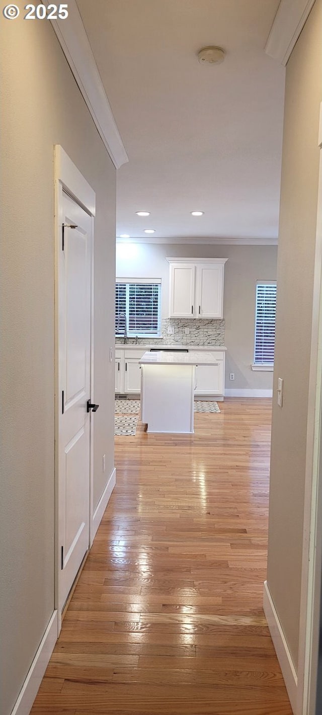 2659 SW Latourell Pl SW, Troutdale, OR 97060 - kitchen featuring white cabinets, tasteful backsplash, light wood finished floors, a center island, and baseboards