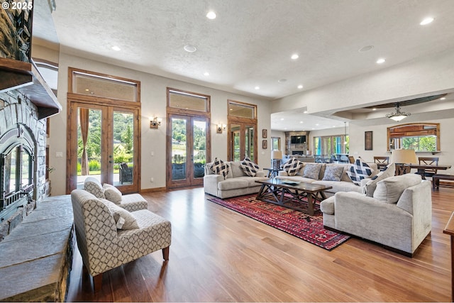 1025 Echo Dr, Roseburg, OR 97470 - living room featuring a textured ceiling, wood finished floors, french doors, and recessed lighting