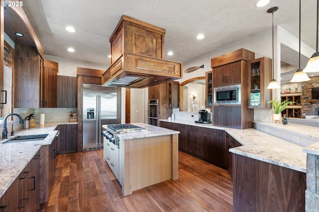 1025 Echo Dr, Roseburg, OR 97470 - kitchen with built in appliances, decorative backsplash, dark wood-type flooring, light stone counters, and recessed lighting