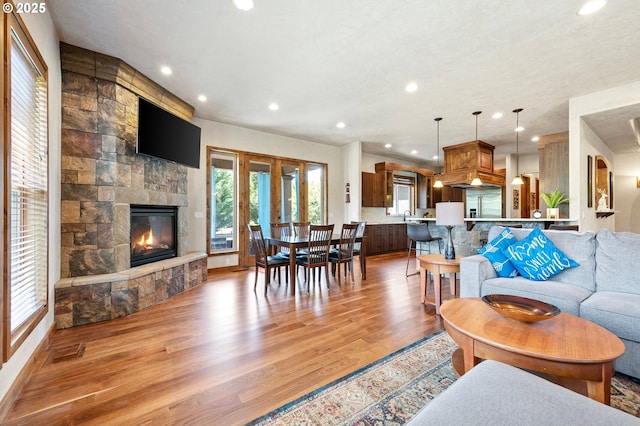 1025 Echo Dr, Roseburg, OR 97470 - living area featuring light wood finished floors, a fireplace, recessed lighting, and french doors