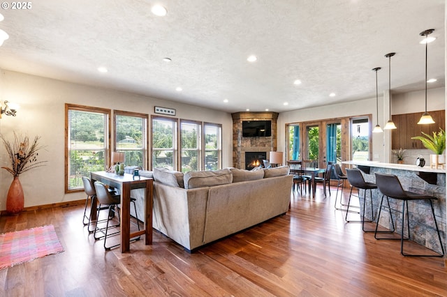 1025 Echo Dr, Roseburg, OR 97470 - living room with a stone fireplace, recessed lighting, wood finished floors, and a textured ceiling