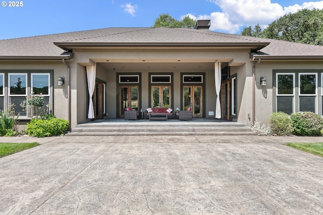 1025 Echo Dr, Roseburg, OR 97470 - entrance to property with stucco siding, an outdoor hangout area, french doors, a chimney, and roof with shingles