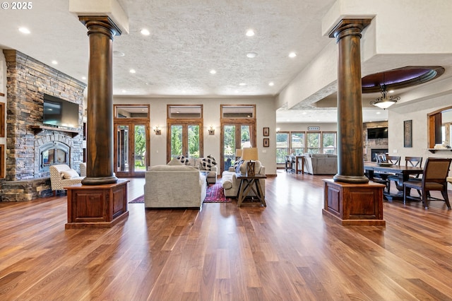 1025 Echo Dr, Roseburg, OR 97470 - living area with decorative columns, wood finished floors, and recessed lighting