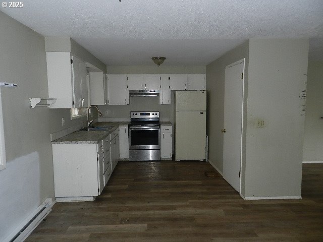 kitchen with white cabinets, a baseboard heating unit, white fridge, sink, and stainless steel electric range oven