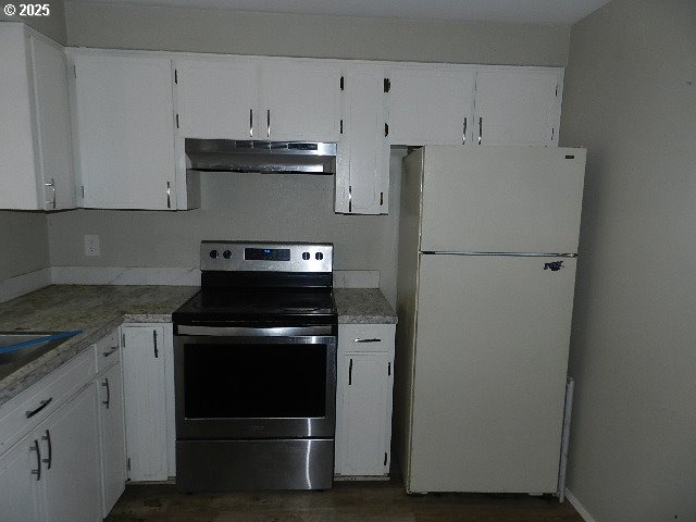 kitchen with white cabinets, stainless steel electric range, and white refrigerator