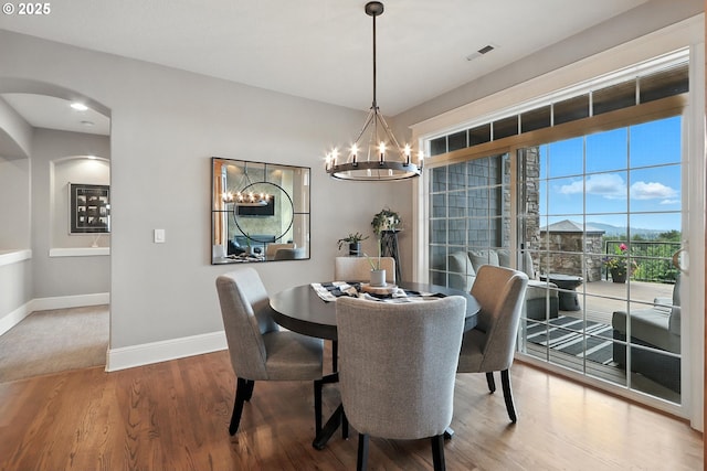 8547 SE Constance Dr, Happy Valley, OR 97086 - dining room featuring a chandelier, wood finished floors, and arched walkways