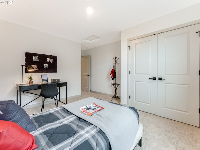 bedroom featuring attic access, a closet, light carpet, and baseboards