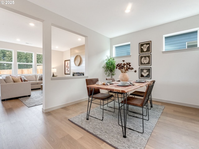 dining space featuring light wood-type flooring, baseboards, and recessed lighting