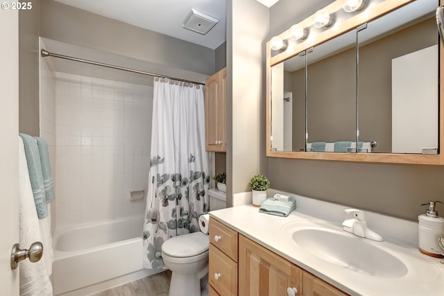 full bathroom featuring shower / tub combo with curtain, vanity, hardwood / wood-style floors, and toilet